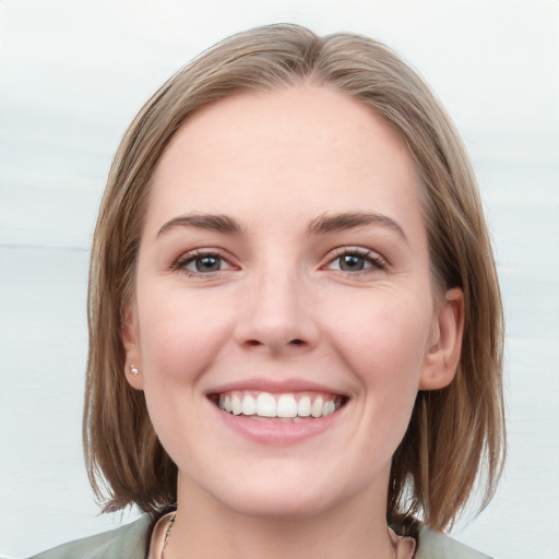 Joyful white young-adult female with medium  brown hair and blue eyes