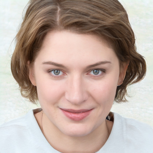 Joyful white young-adult female with medium  brown hair and blue eyes