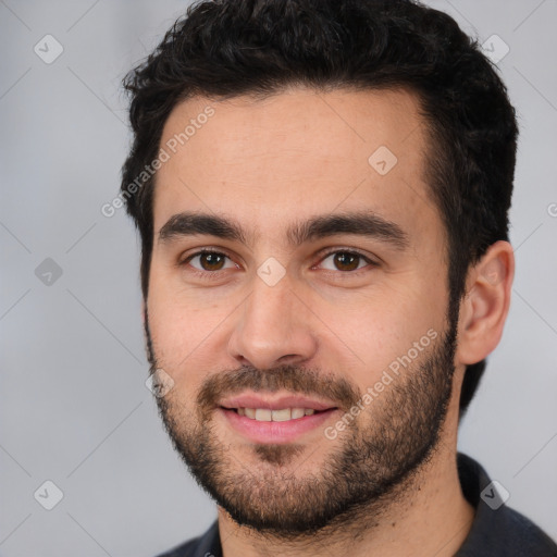 Joyful white young-adult male with short  black hair and brown eyes