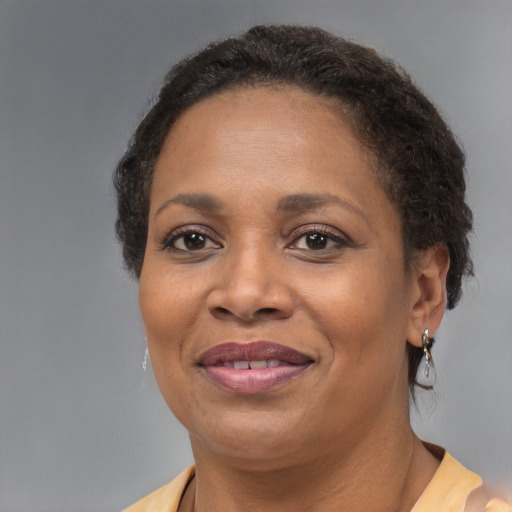 Joyful black adult female with medium  brown hair and brown eyes