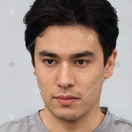 Neutral white young-adult male with short  black hair and brown eyes