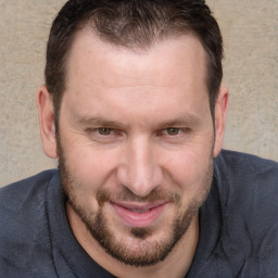 Joyful white adult male with short  brown hair and brown eyes