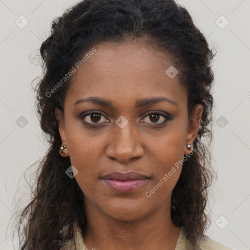 Joyful black young-adult female with long  brown hair and brown eyes