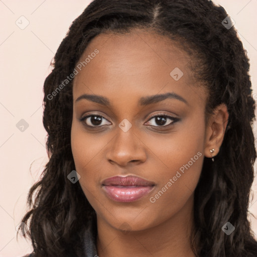 Joyful black young-adult female with long  brown hair and brown eyes