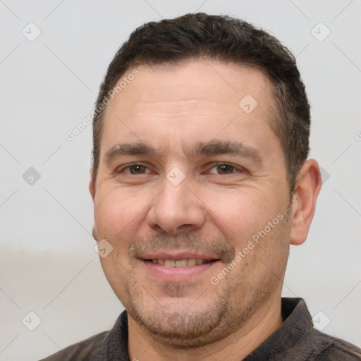 Joyful white adult male with short  brown hair and brown eyes