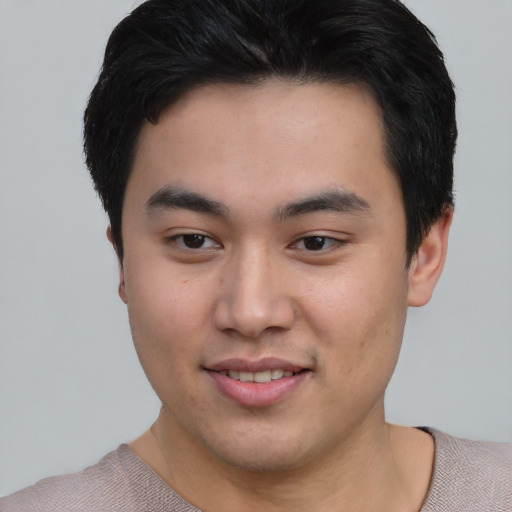 Joyful asian young-adult male with short  brown hair and brown eyes