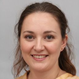 Joyful white young-adult female with medium  brown hair and brown eyes