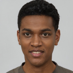 Joyful black young-adult male with short  black hair and brown eyes