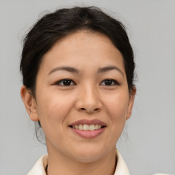 Joyful asian young-adult female with medium  brown hair and brown eyes