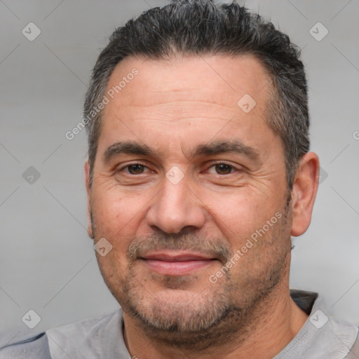 Joyful white adult male with short  black hair and brown eyes
