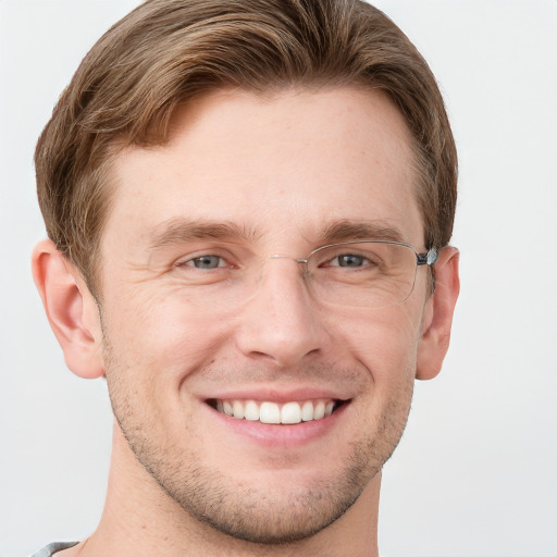 Joyful white adult male with short  brown hair and grey eyes