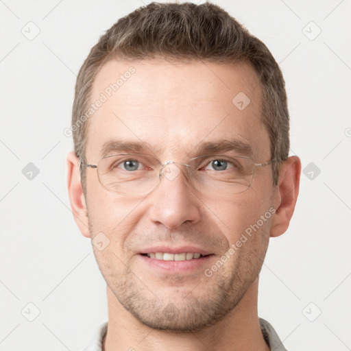 Joyful white adult male with short  brown hair and grey eyes