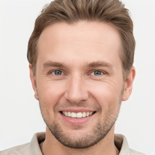 Joyful white young-adult male with short  brown hair and grey eyes