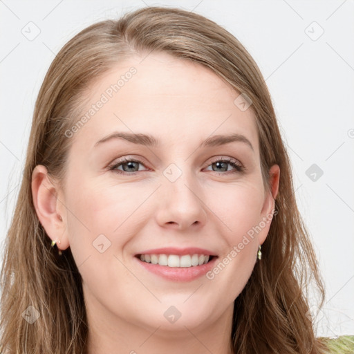 Joyful white young-adult female with long  brown hair and blue eyes