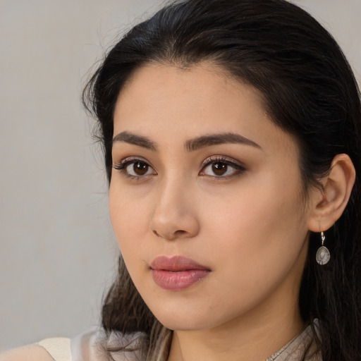 Neutral latino young-adult female with long  brown hair and brown eyes