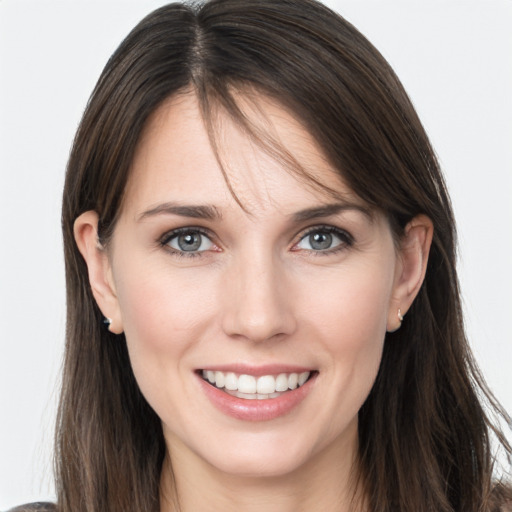 Joyful white young-adult female with long  brown hair and grey eyes