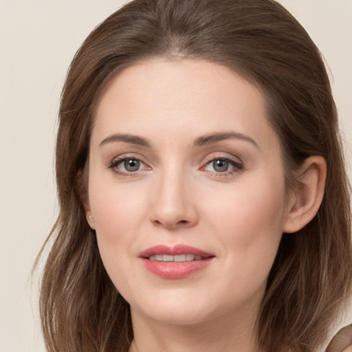 Joyful white young-adult female with long  brown hair and grey eyes