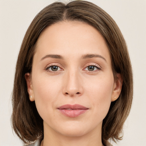 Joyful white young-adult female with medium  brown hair and green eyes