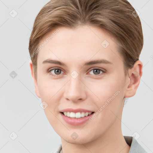 Joyful white young-adult female with short  brown hair and grey eyes