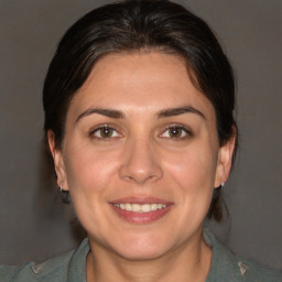 Joyful white adult female with medium  brown hair and brown eyes