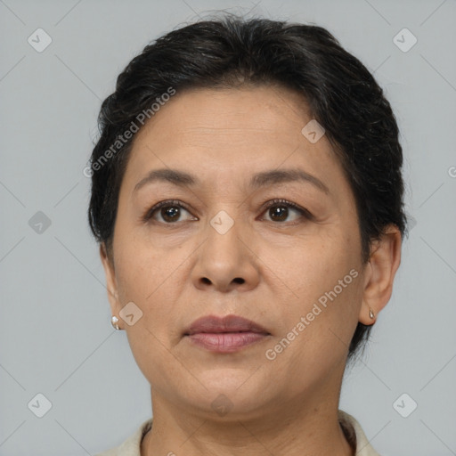 Joyful latino adult female with short  brown hair and brown eyes