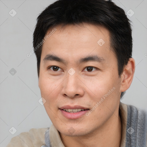 Joyful asian young-adult male with short  brown hair and brown eyes
