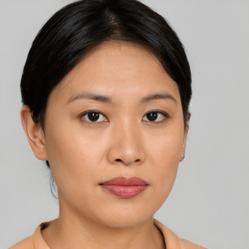 Joyful asian young-adult female with short  brown hair and brown eyes