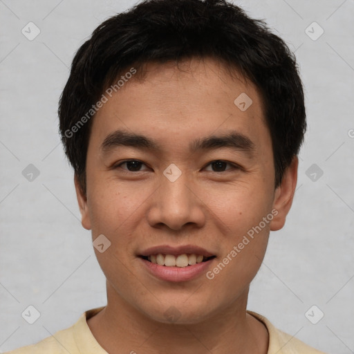 Joyful asian young-adult male with short  brown hair and brown eyes