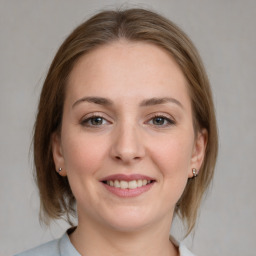 Joyful white young-adult female with medium  brown hair and grey eyes