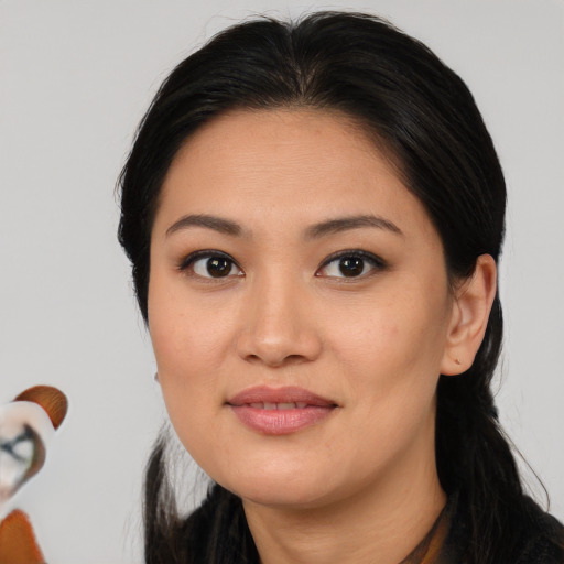 Joyful asian young-adult female with medium  brown hair and brown eyes