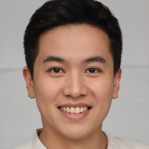 Joyful asian young-adult male with short  brown hair and brown eyes