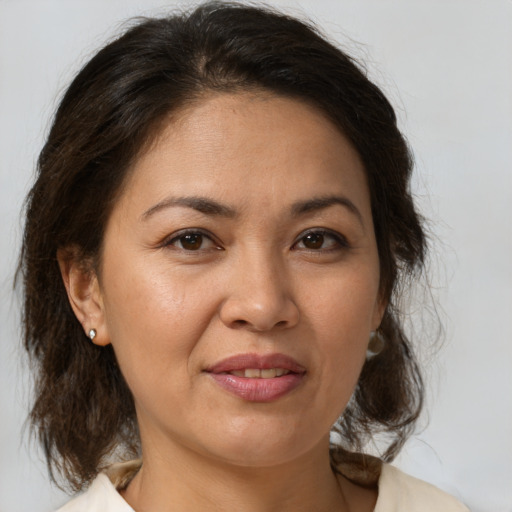 Joyful white adult female with medium  brown hair and brown eyes