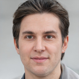 Joyful white adult male with short  brown hair and grey eyes