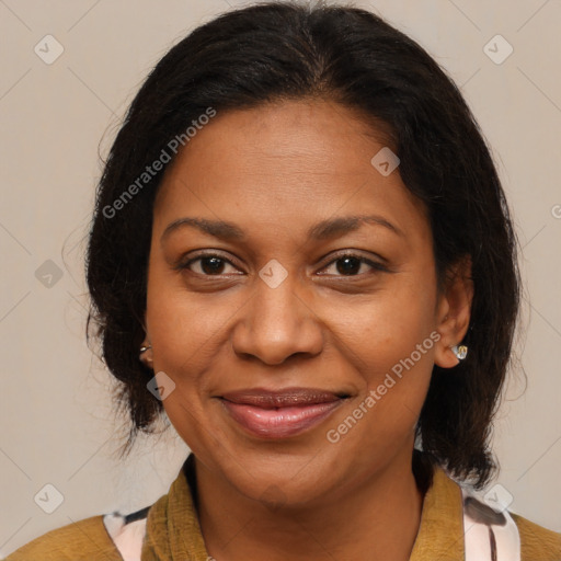 Joyful black adult female with medium  brown hair and brown eyes