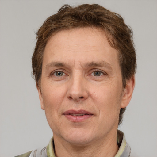 Joyful white adult male with short  brown hair and grey eyes