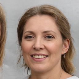 Joyful white adult female with medium  brown hair and brown eyes