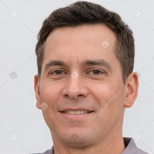 Joyful white adult male with short  brown hair and brown eyes