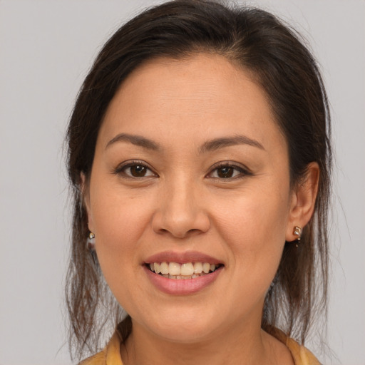 Joyful white young-adult female with medium  brown hair and brown eyes