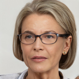 Joyful white adult female with medium  brown hair and blue eyes