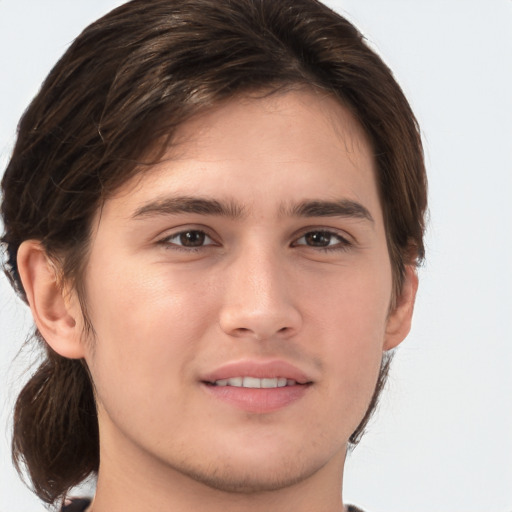 Joyful white young-adult male with medium  brown hair and brown eyes