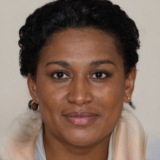 Joyful black adult female with short  brown hair and brown eyes