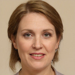 Joyful white adult female with medium  brown hair and grey eyes