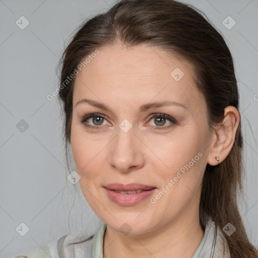 Joyful white adult female with medium  brown hair and grey eyes