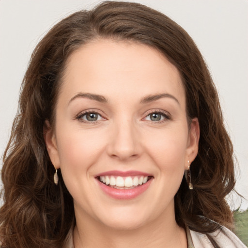 Joyful white young-adult female with long  brown hair and green eyes