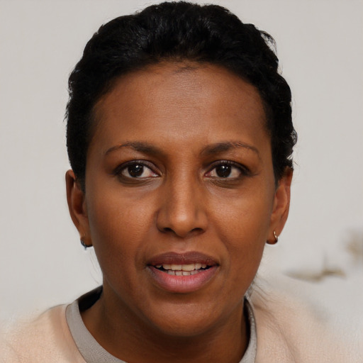 Joyful black young-adult female with short  brown hair and brown eyes