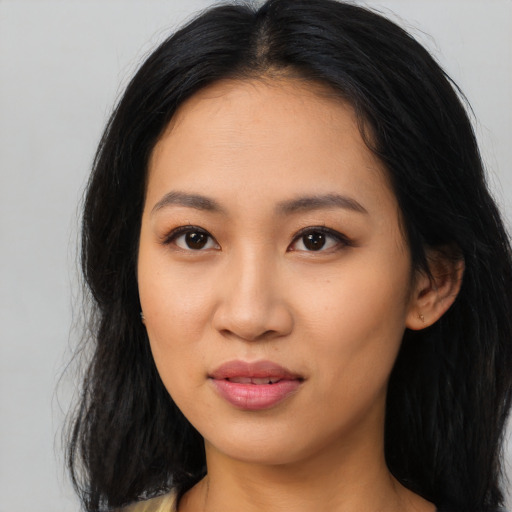 Joyful latino young-adult female with long  black hair and brown eyes
