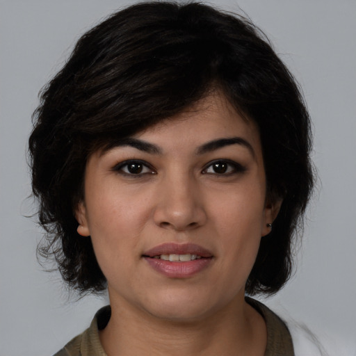 Joyful white young-adult female with medium  black hair and brown eyes