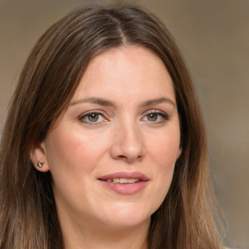 Joyful white young-adult female with long  brown hair and green eyes