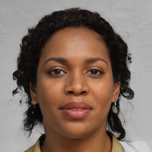Joyful black young-adult female with medium  black hair and brown eyes