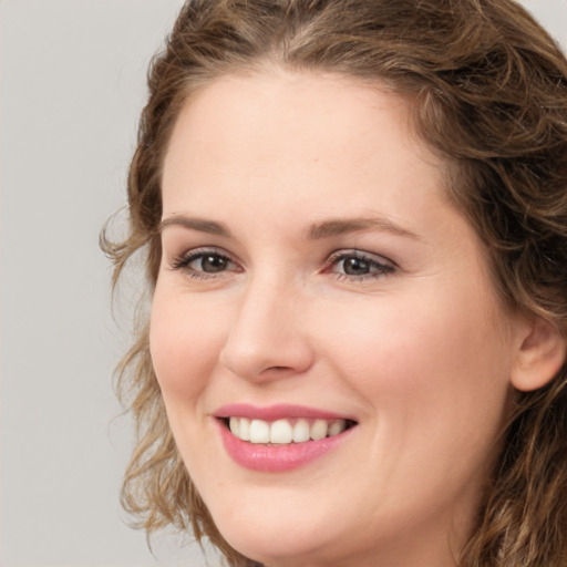 Joyful white young-adult female with medium  brown hair and green eyes